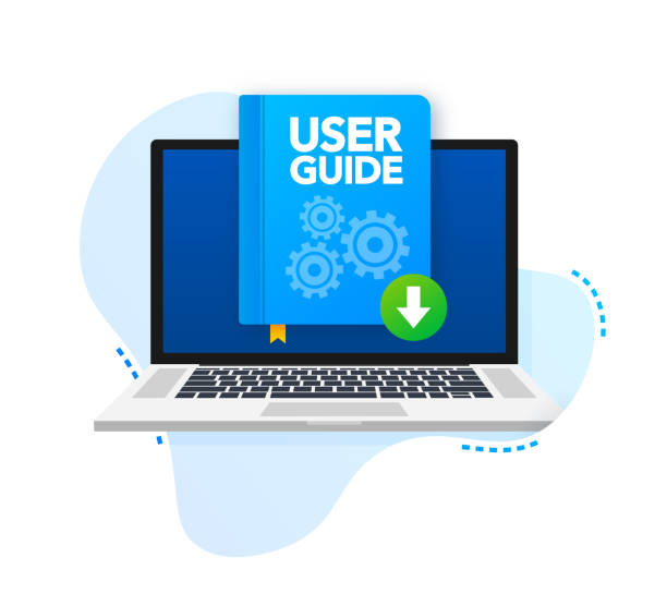 An open laptop and a user manual